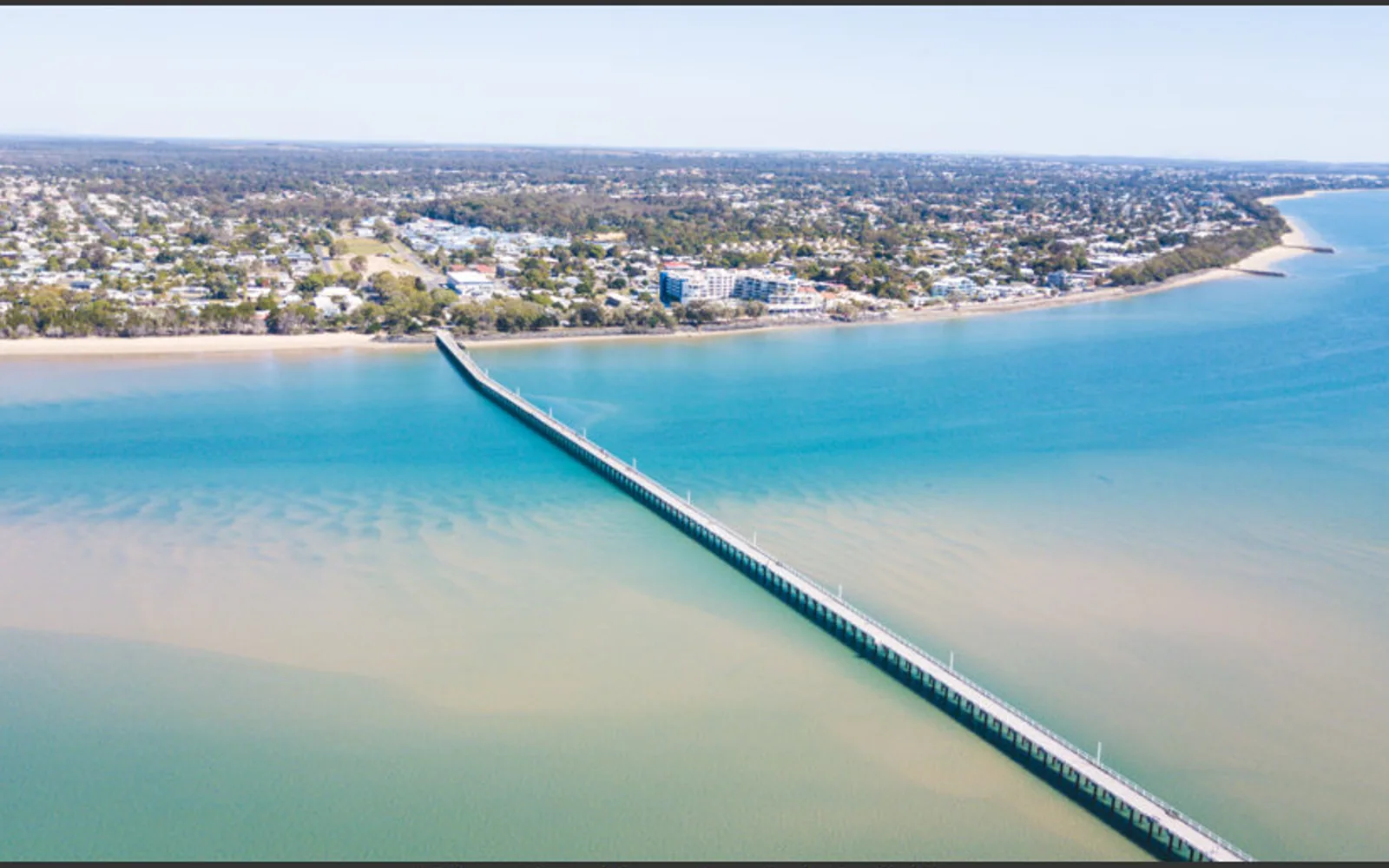 Urangan Pier stretching across the blue water at Hervey Bay